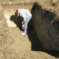 student identifying soil types in pit